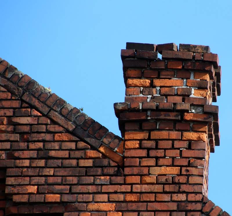 Signs Your Upton Home Needs a Chimney Inspection Damaged chimney on an Upton home showing cracks and missing mortar